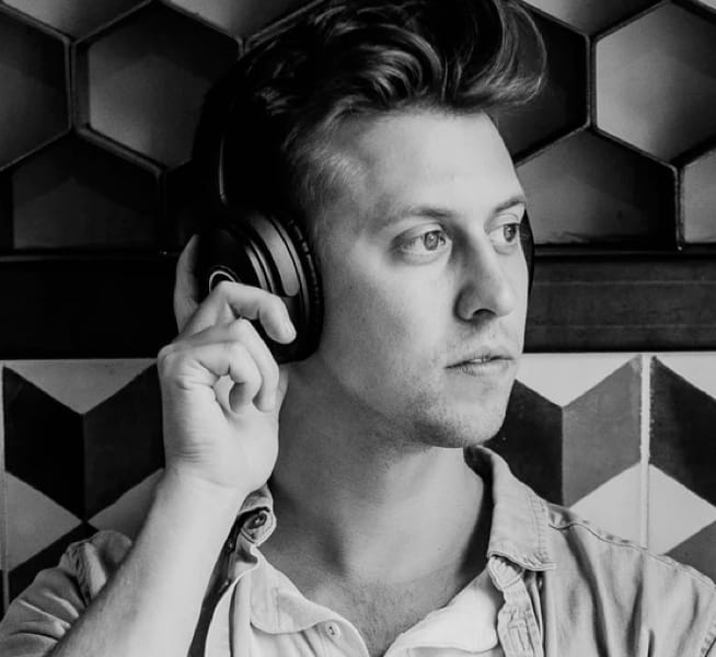 a black-and-white image of a man wearing headphones posing
